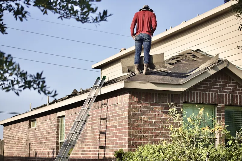 Professional roofer working on a residential roof in Umatilla